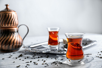 Turkish tea in traditional glass on wooden background