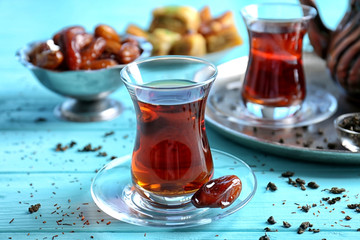 Turkish tea in traditional glass on wooden background