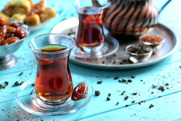 Turkish tea in traditional glass on wooden background