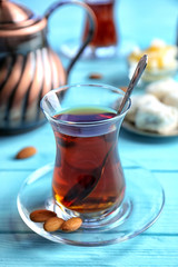 Turkish tea in traditional glass on wooden background
