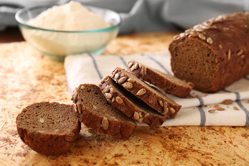 Sliced bread with seeds on table closeup