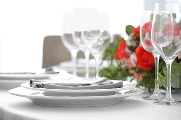 Elegant table setting with beautiful flowers, closeup