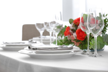 Elegant table setting with beautiful flowers, closeup