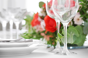 Elegant table setting with beautiful flowers, closeup