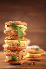 Delicious lemon ice cream cookie sandwiches on wooden background