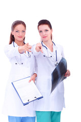 Two woman nurse watching X Ray image, standing in hospital, pointing you