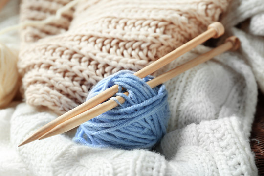 Yarn and needles on plaid, closeup
