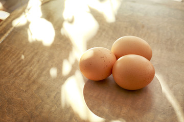 Raw eggs on wooden background