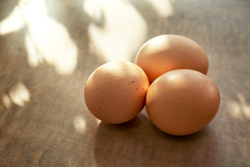 Raw eggs on wooden background