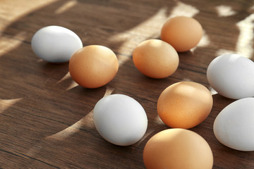 Raw eggs on wooden background