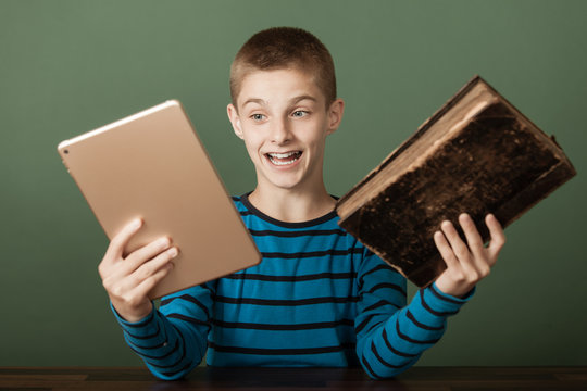 Excited Boy Comparing Two Books