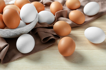 Plate with raw eggs on kitchen table