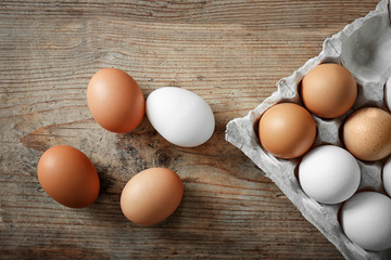 Raw eggs on wooden background