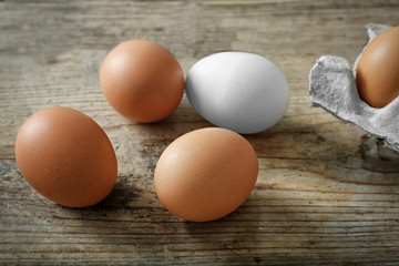 Raw eggs on wooden background