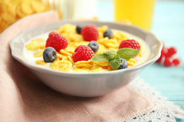 Tasty cornflakes with raspberries and blueberries, close up