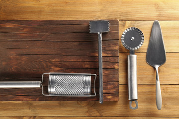 Set of kitchen stainless tools on wooden table