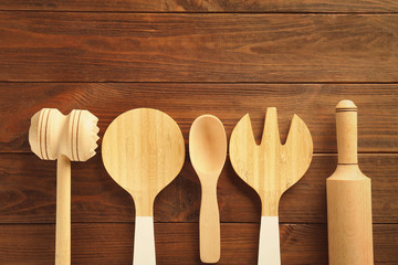 Set of different kitchen tools on wooden table
