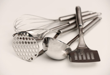 Set of metal kitchen utensils on table