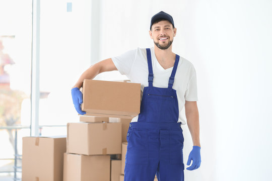 House moving concept. Man holding cardboard box indoor