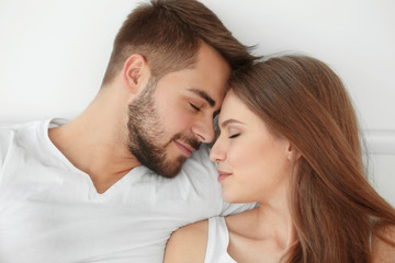 Portrait of cute young couple at home