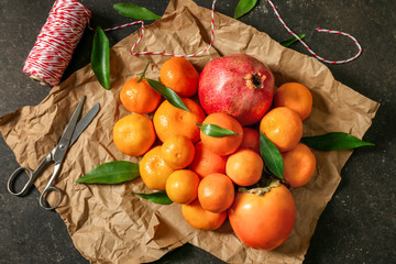 Set of tangerines and juice fruits on wrapping paper