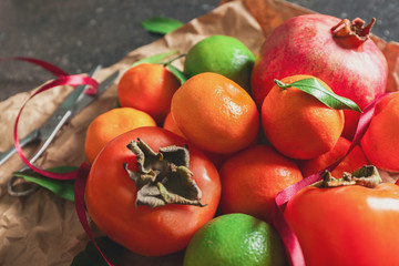 Set of tangerines and juice fruits on wrapping paper