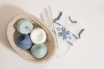Fototapeta na wymiar knitting clothes for the newborn on a white background. needles