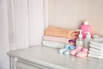 Baby necessities on white chest of drawers