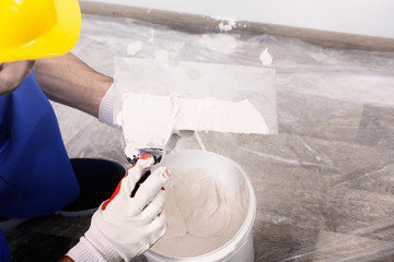 Professional worker making repair in room