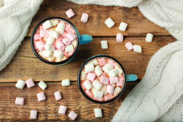Cups of hot cocoa with marshmallows on table