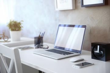 Fototapeta na wymiar Modern workplace with laptop on table