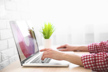 Closeup of woman working on laptop