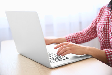 Closeup of woman working on laptop