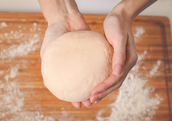 Woman making dough at kitchen