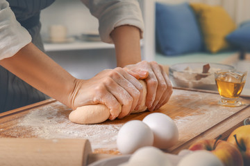 Woman making dough at kitchen