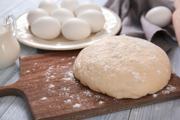 Closeup of raw dough on wooden board