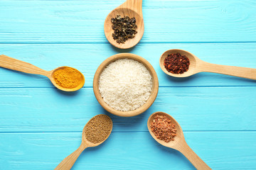 Rice and spices on wooden table