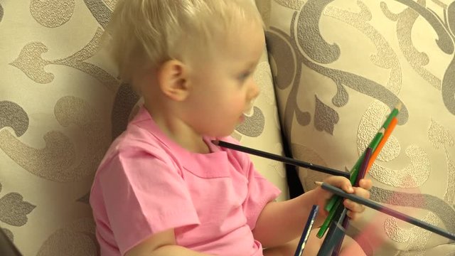 Newborn Little Girl Playing with Pencils. 4K UltraHD video.