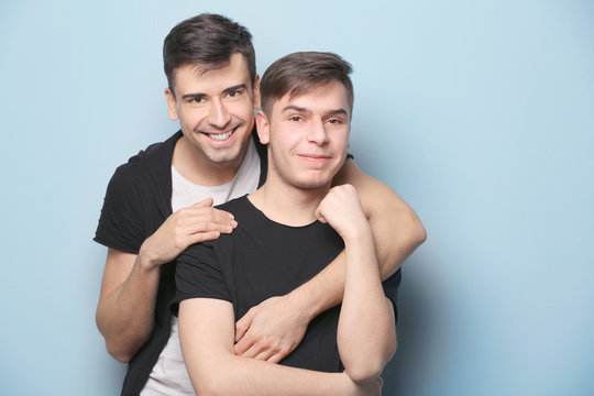 Happy Gay Couple Posing On Light Background