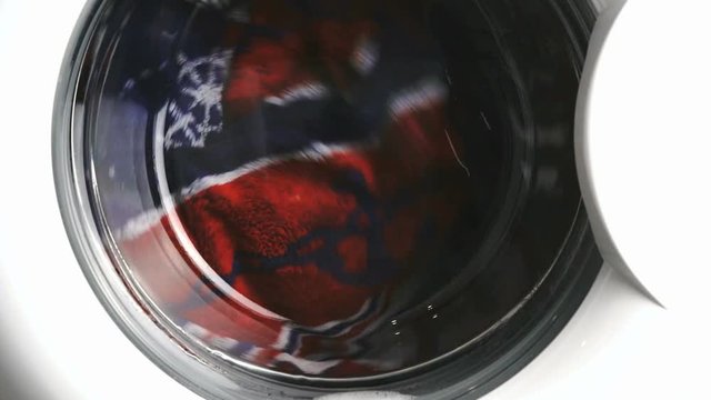 Washing machine downloaded colored towels. Working process. Close up