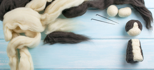 Workplace with tools, needle and skeins of wool for felting toys.