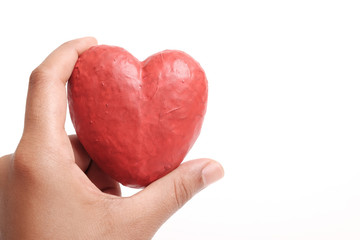 Hand holding red heart.