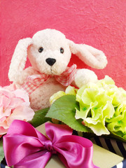 cute teddy bear with gift and beautiful bouquet flower
