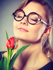 Charming woman smelling flower feel peace.