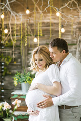 happy husband and pregnant wife in a cafe