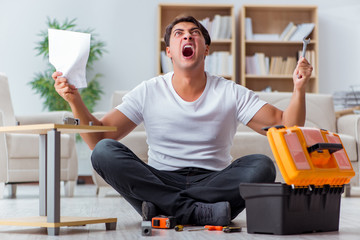 Man assembling furniture at home