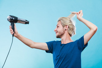 Trendy man with hair dryer