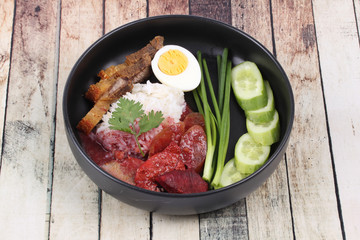 Jasmine rice with meat and boiled egg topped red sweet sauce .