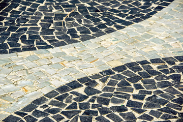 Black and white iconic mosaic, Portuguese pavement by old design pattern at Copacabana Beach, Rio...