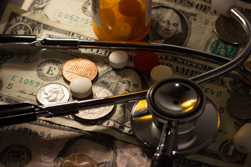 Money prescription medication pills and stethoscope medical, the cost of health care in america